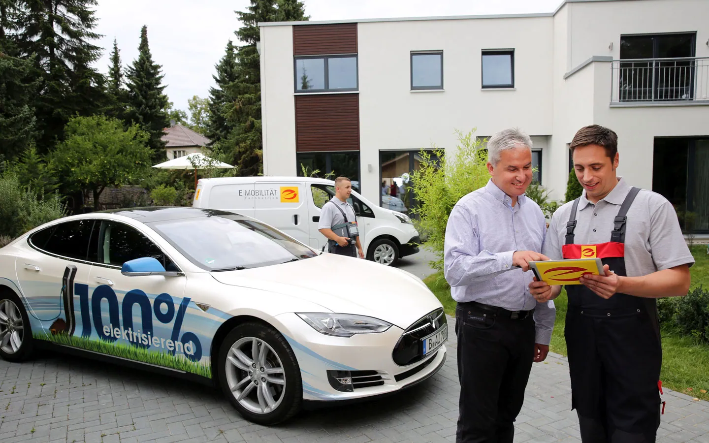 E-Mobilität - Mitarbeiter mit Kunden vor Elektrofahrzeugen 100% elektrisch &middot; Elektro-Diehm